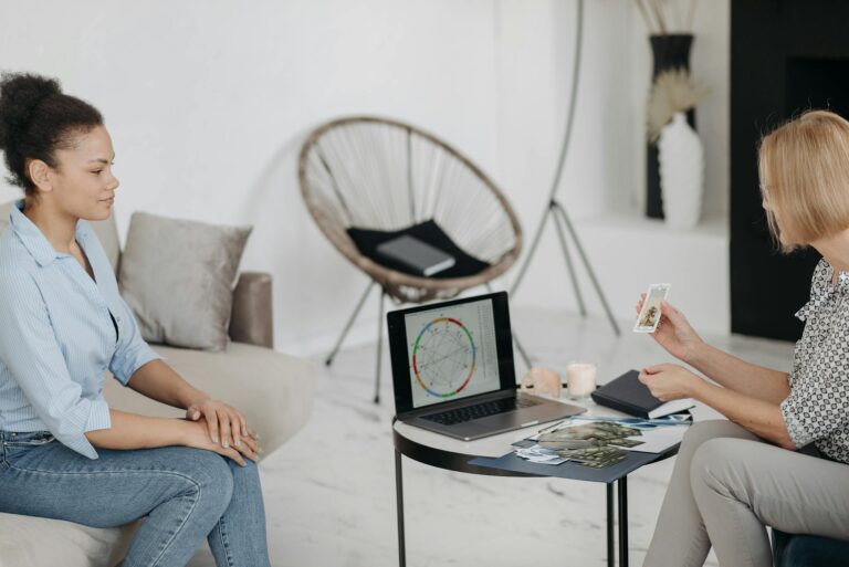 A tarot reader interprets cards and an astrological chart in a serene setting.