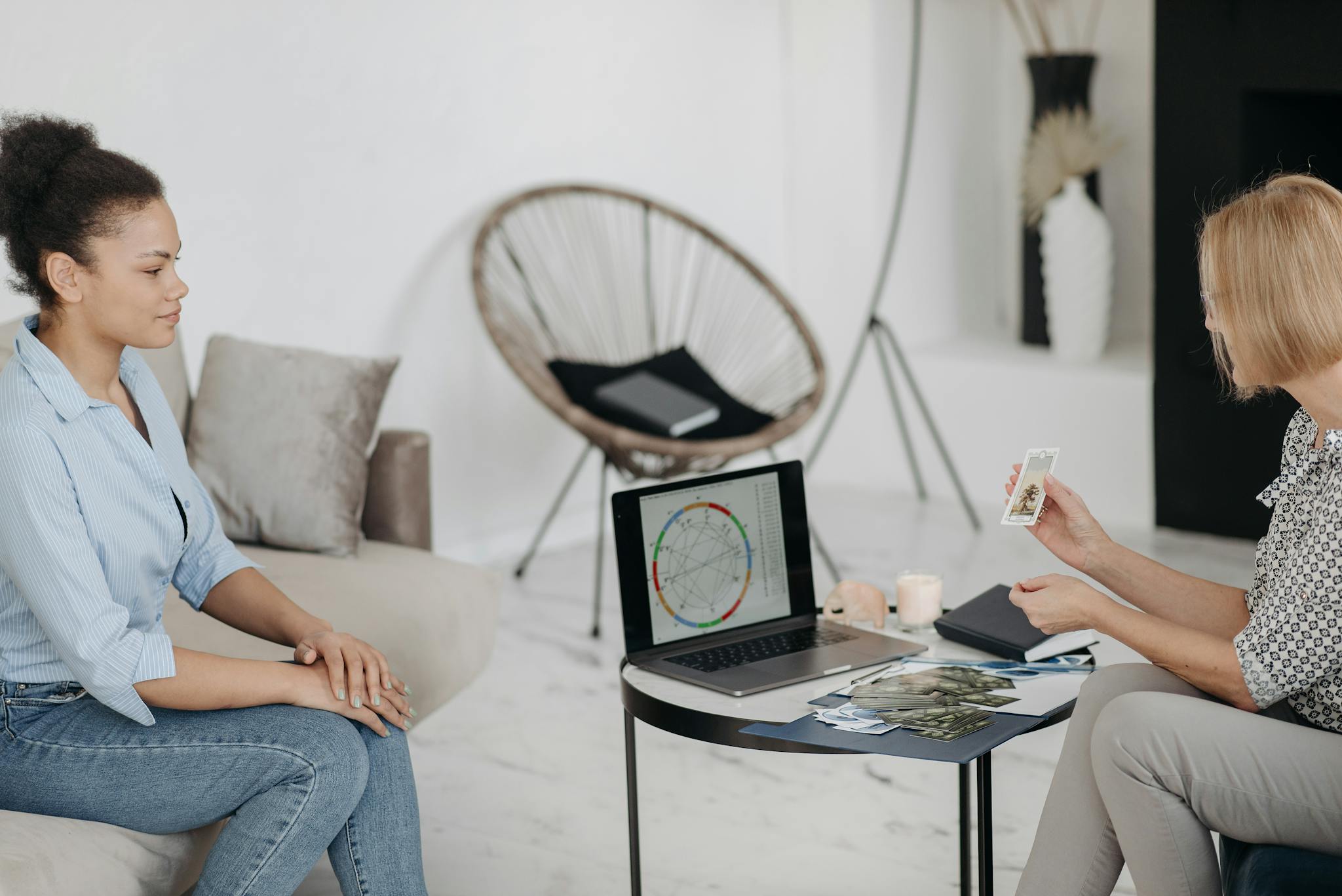 A tarot reader interprets cards and an astrological chart in a serene setting.